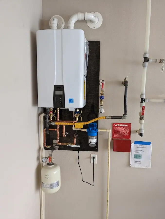 Professional plumber installing copper piping in a Neshannock home